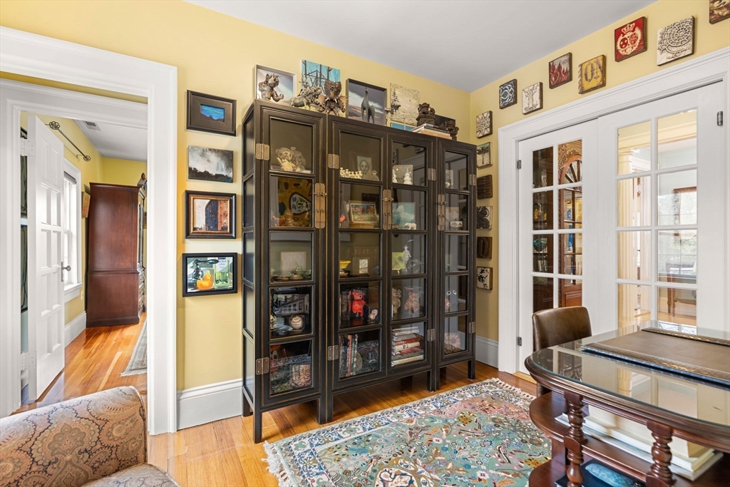 79 Wedge Street Lowell, MA 01851 - Photo 34 of 42 a living room with furniture a rug and a chandelier