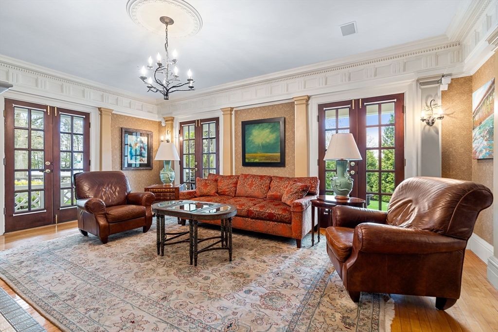 79 Wedge Street Lowell, MA 01851 - Photo 6 of 42 a living room with furniture and a chandelier