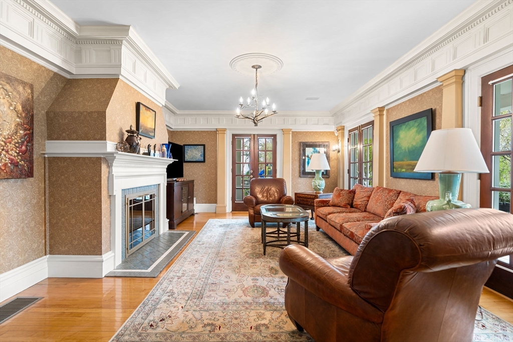79 Wedge Street Lowell, MA 01851 - Photo 7 of 42 a living room with furniture a fireplace and a chandelier