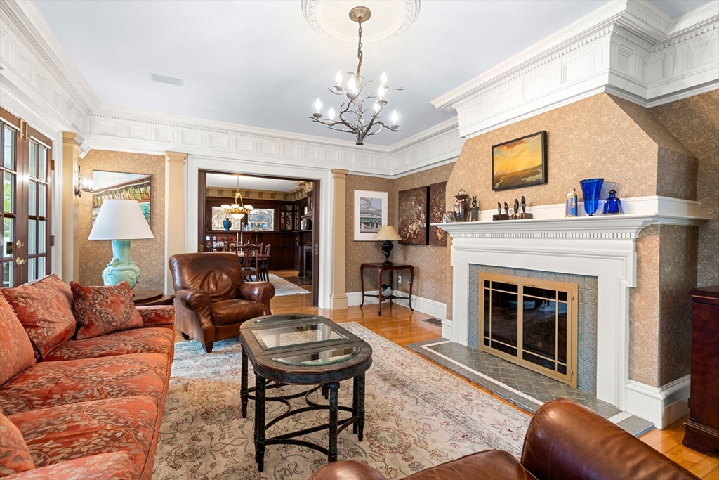79 Wedge Street Lowell, MA 01851 - Photo 8 of 42 a living room with furniture a chandelier and a fireplace