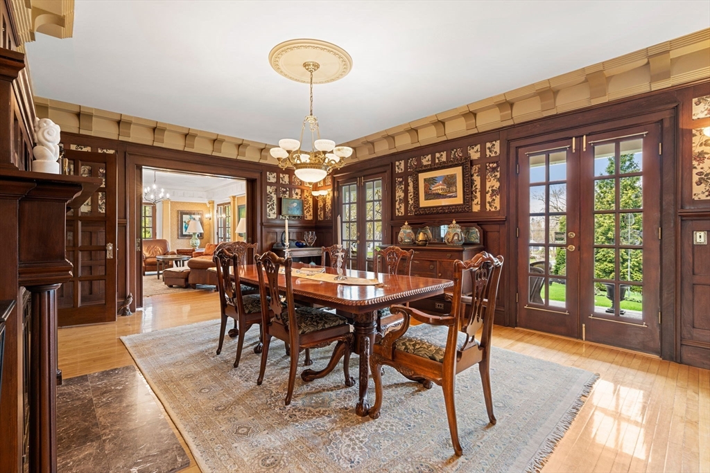 79 Wedge Street Lowell, MA 01851 - Photo 9 of 42 a dining room with furniture a chandelier and wooden floor