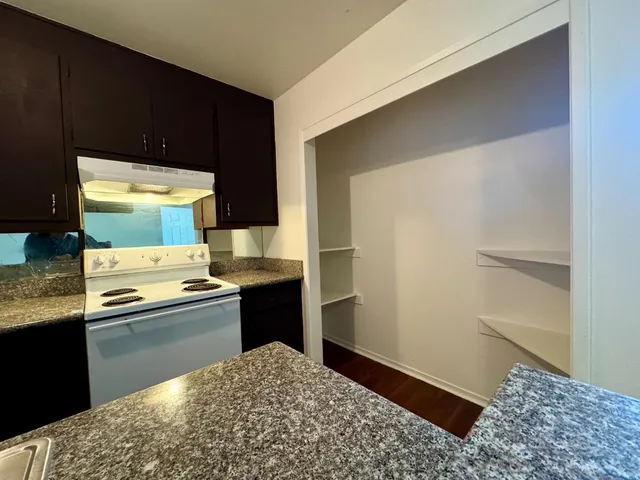 a kitchen with a sink and a stove top oven