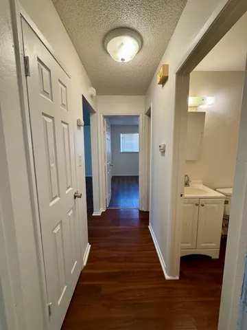 a view of a hallway with wooden floor