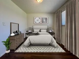 a bedroom with a bed and a dresser