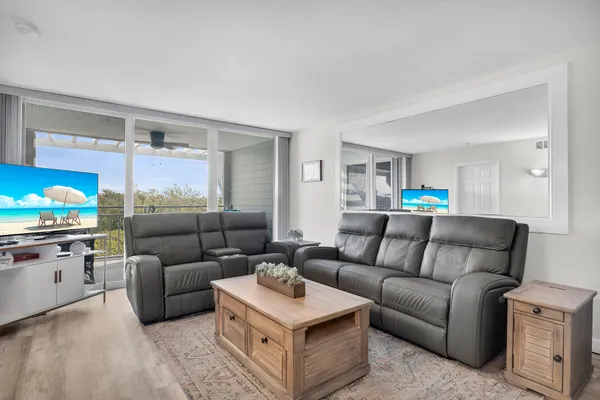 a living room with furniture and a kitchen view