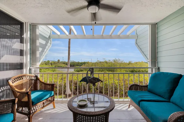 a balcony with table and chairs