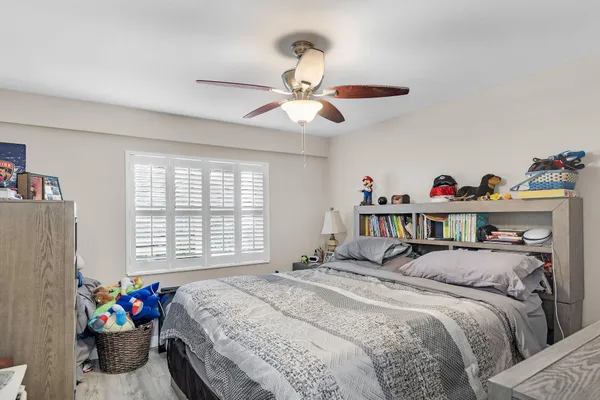 a bed room with a bed and a chandelier