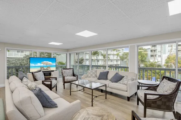a view of a dining room with furniture floor to ceiling window and wooden floor