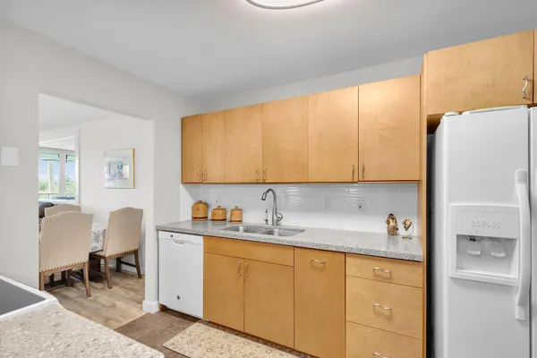 a kitchen with a sink cabinets and a window