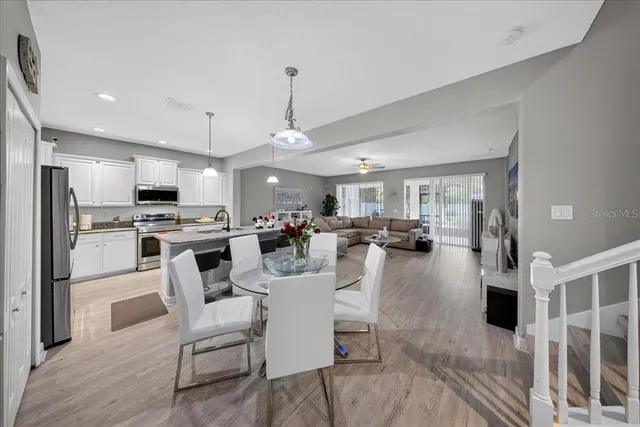 an aerial view of a house with backyard space and swimming pool