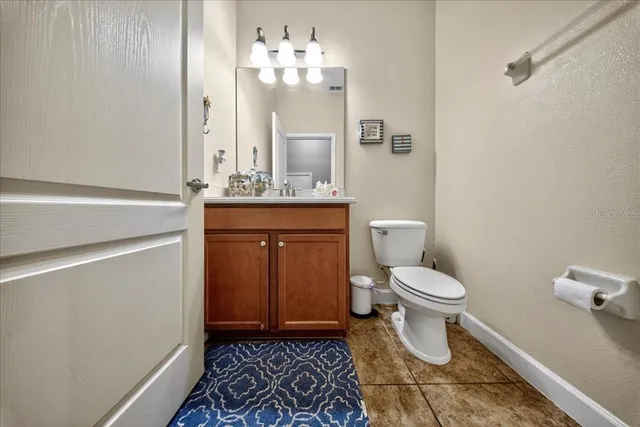 a view of lake with a big yard and large trees