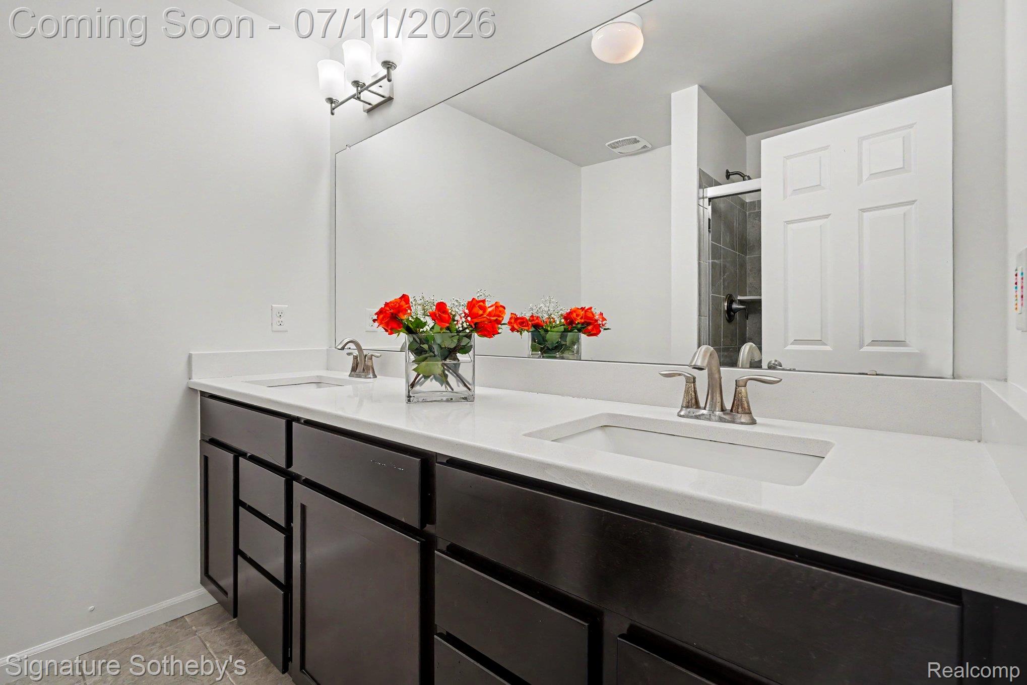 2500 Normandy Road, Unit 40 Royal Oak, MI 48073 - Photo 20 of 26 Dual vanity with white countertops, undermount sinks, and brushed nickel faucets