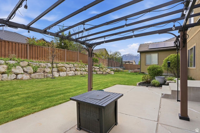 2007 Fielding Hill Lane Draper, UT 84020 - Photo 44 of 83 Patio featuring a dark-toned pergola with string lighting, a concrete surface, and steps leading from the property