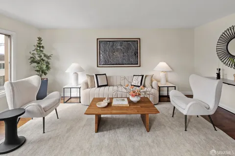 a living room with furniture and a potted plant