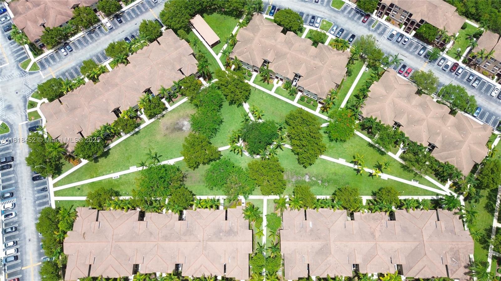 22901 Southwest 88th Place, Unit 101 Cutler Bay, FL 33190 - Photo 16 of 16 an aerial view of a yard