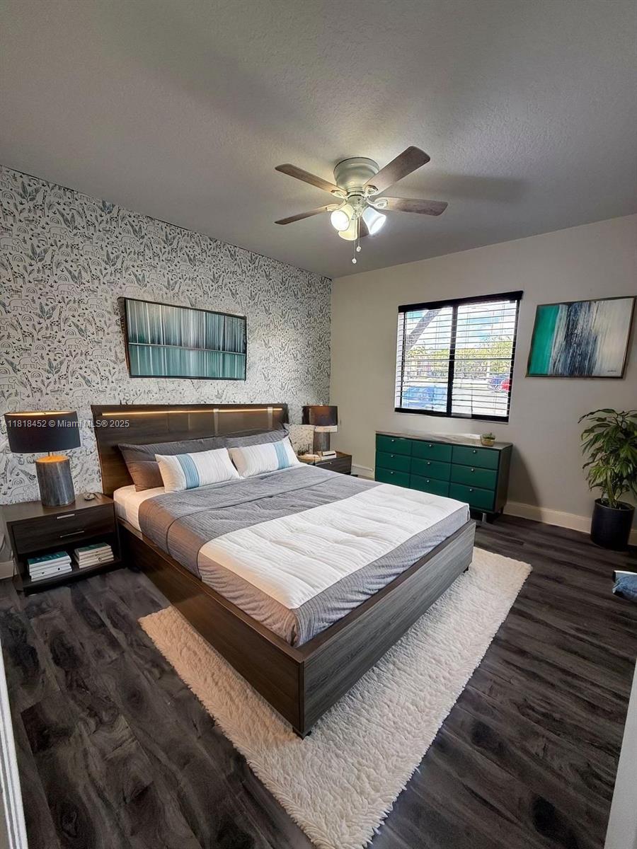 22901 Southwest 88th Place, Unit 101 Cutler Bay, FL 33190 - Photo 6 of 16 a bedroom with bed and window