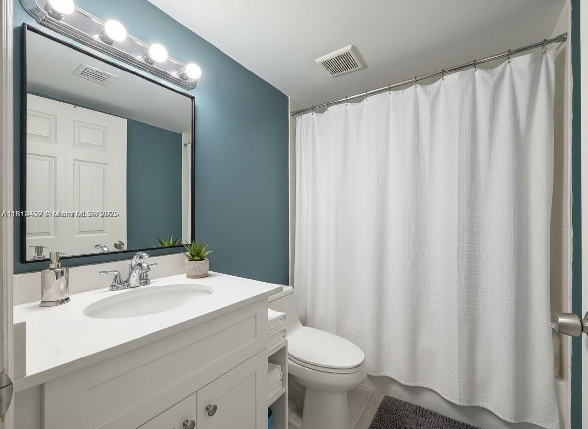 22901 Southwest 88th Place, Unit 101 Cutler Bay, FL 33190 - Photo 8 of 16 a bathroom with a sink toilet and shower