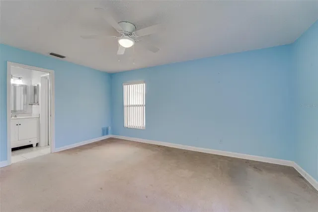 a room with furniture lots of books and a large window