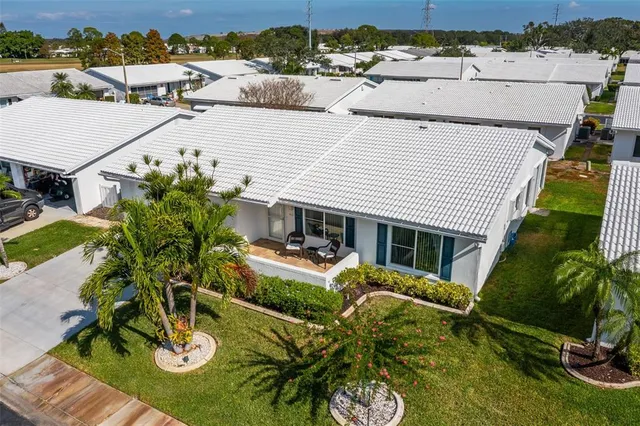 a view of a big room with windows and chandelier fan
