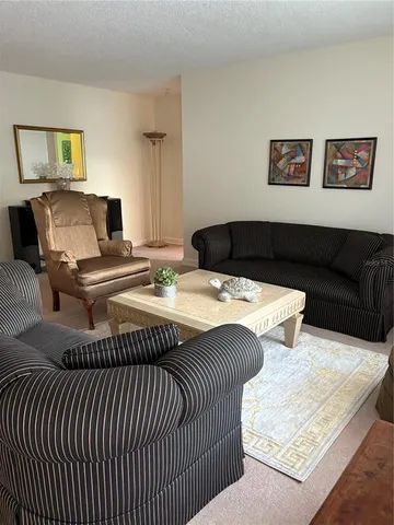 a view of a kitchen and an empty room