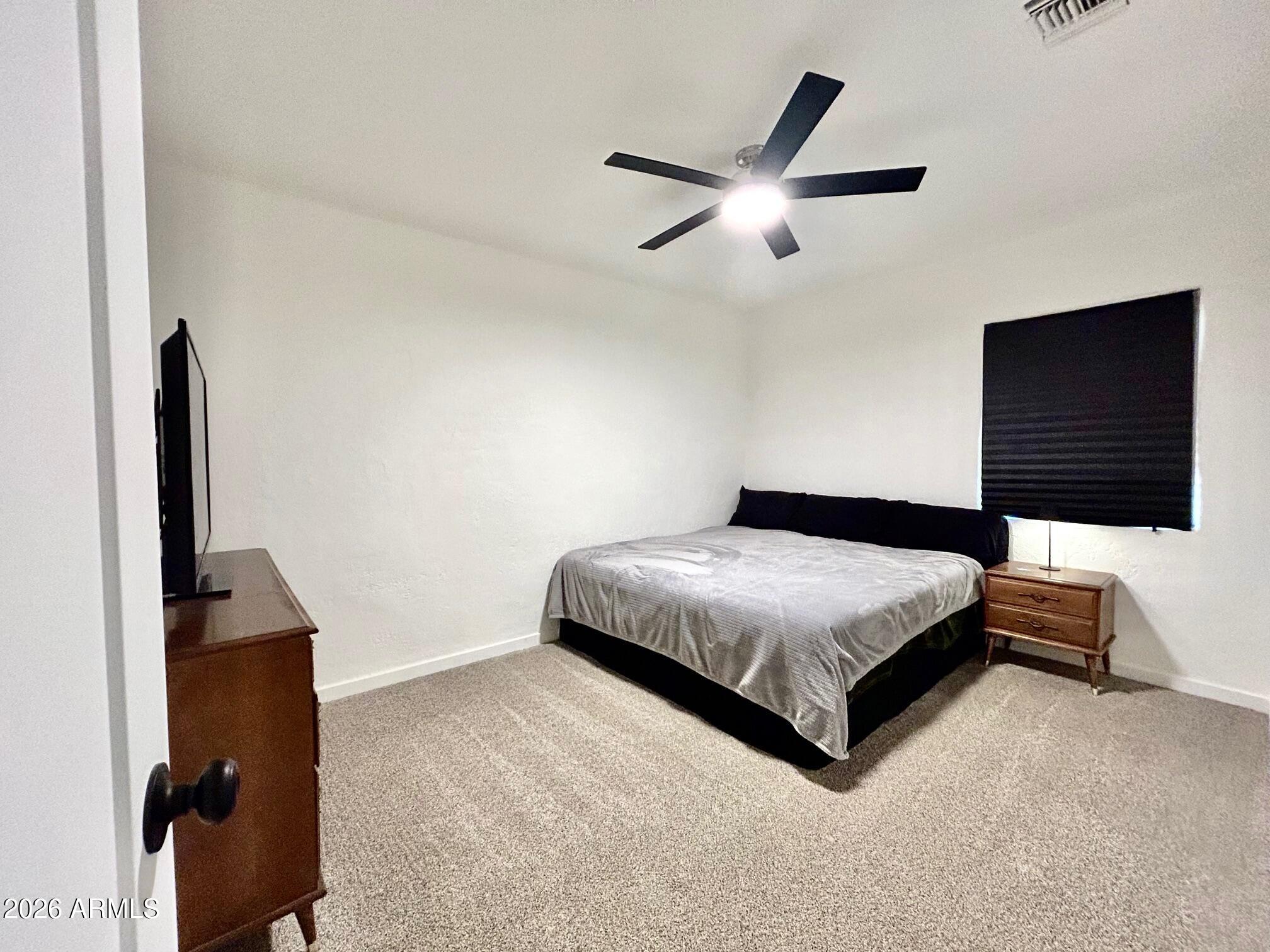702 Paxton Avenue Miami, AZ 85539 - Photo 13 of 15 a bedroom with a bed and a flat screen tv