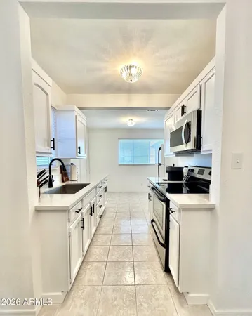 a kitchen with stainless steel appliances granite countertop a sink and a stove