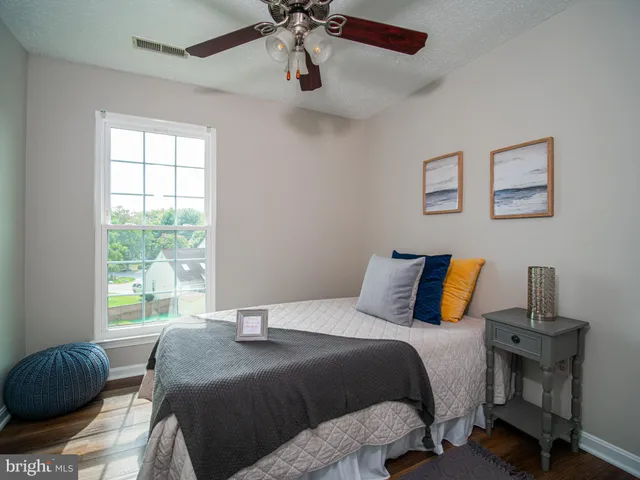 a bedroom with a bed and window