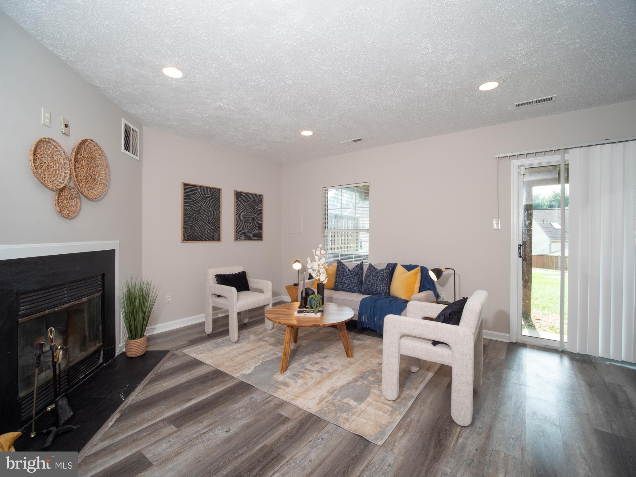 918 Lake Overlook Drive Bowie, MD 20721 - Photo 22 of 29 a living room with furniture two window and a fireplace