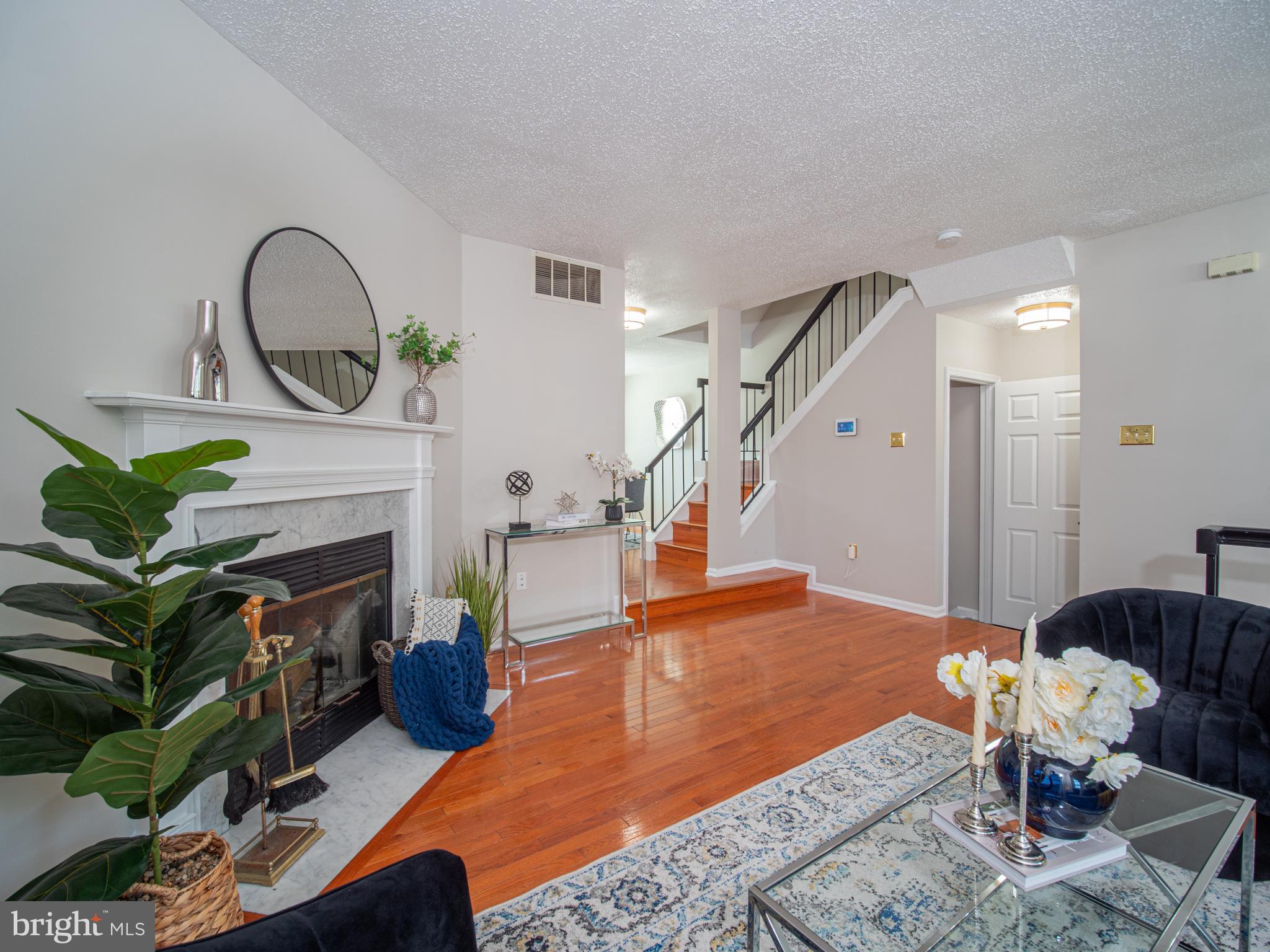 918 Lake Overlook Drive Bowie, MD 20721 - Photo 3 of 29 a living room with furniture a fireplace and a potted plant