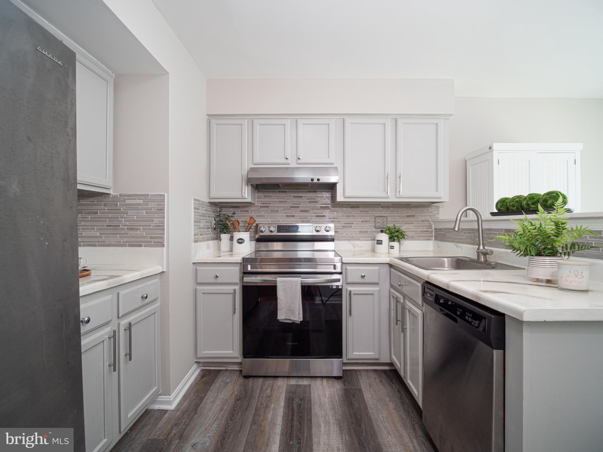 918 Lake Overlook Drive Bowie, MD 20721 - Photo 6 of 29 a kitchen with stainless steel appliances granite countertop a stove sink and cabinets