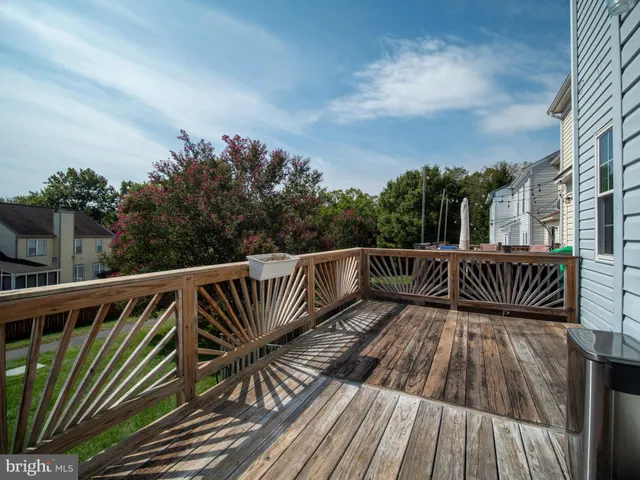 a view of balcony with wooden floor and fence