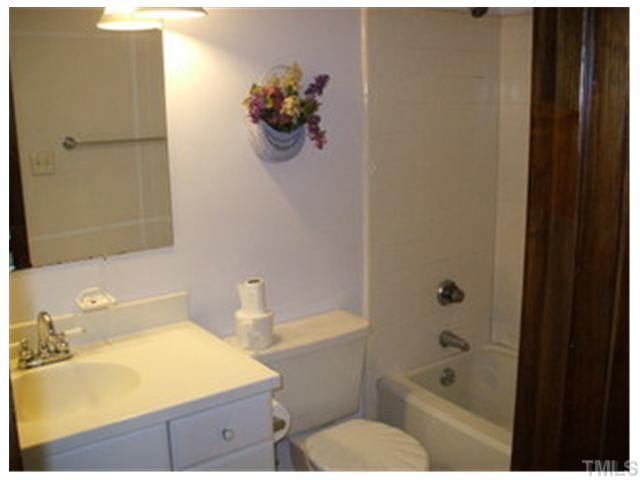 5201 Round Hill Lane Raleigh, NC 27616 - Photo 11 of 14 a bathroom with a sink mirror toilet and bathtub