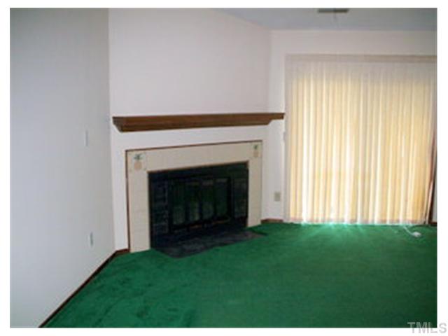 5201 Round Hill Lane Raleigh, NC 27616 - Photo 5 of 14 a view of an empty room with a fireplace and a window