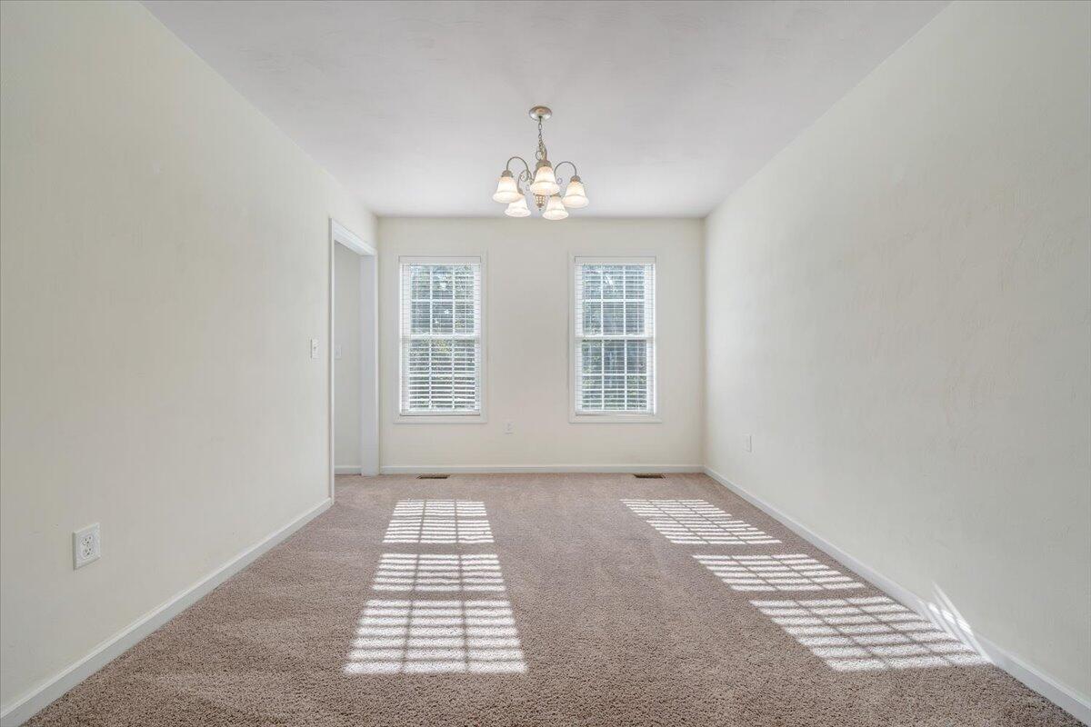 416 Old Fort Road Rocky Mount, VA 24151 - Photo 3 of 28 an empty room with windows and chandelier fan