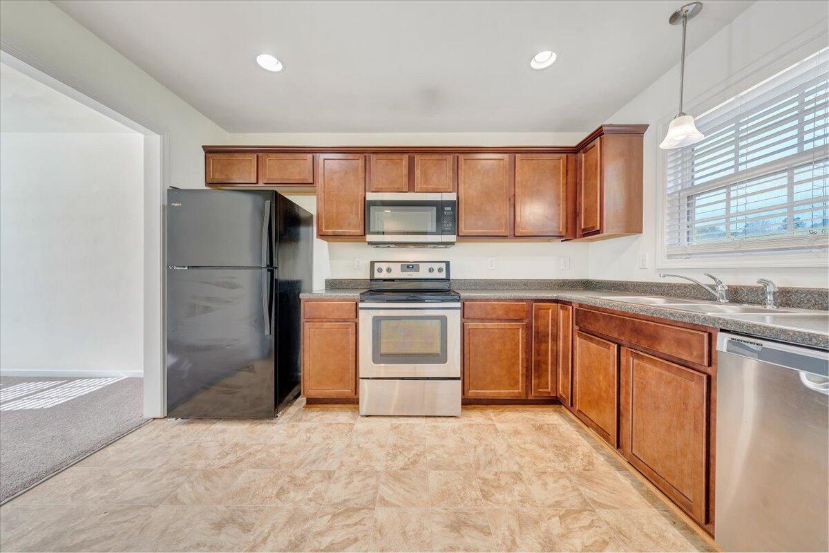 416 Old Fort Road Rocky Mount, VA 24151 - Photo 7 of 28 a kitchen with granite countertop a refrigerator stove top oven and sink