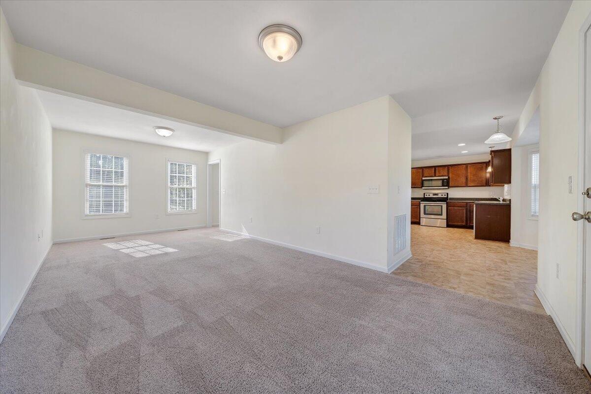 416 Old Fort Road Rocky Mount, VA 24151 - Photo 10 of 28 an empty room with windows and a kitchen