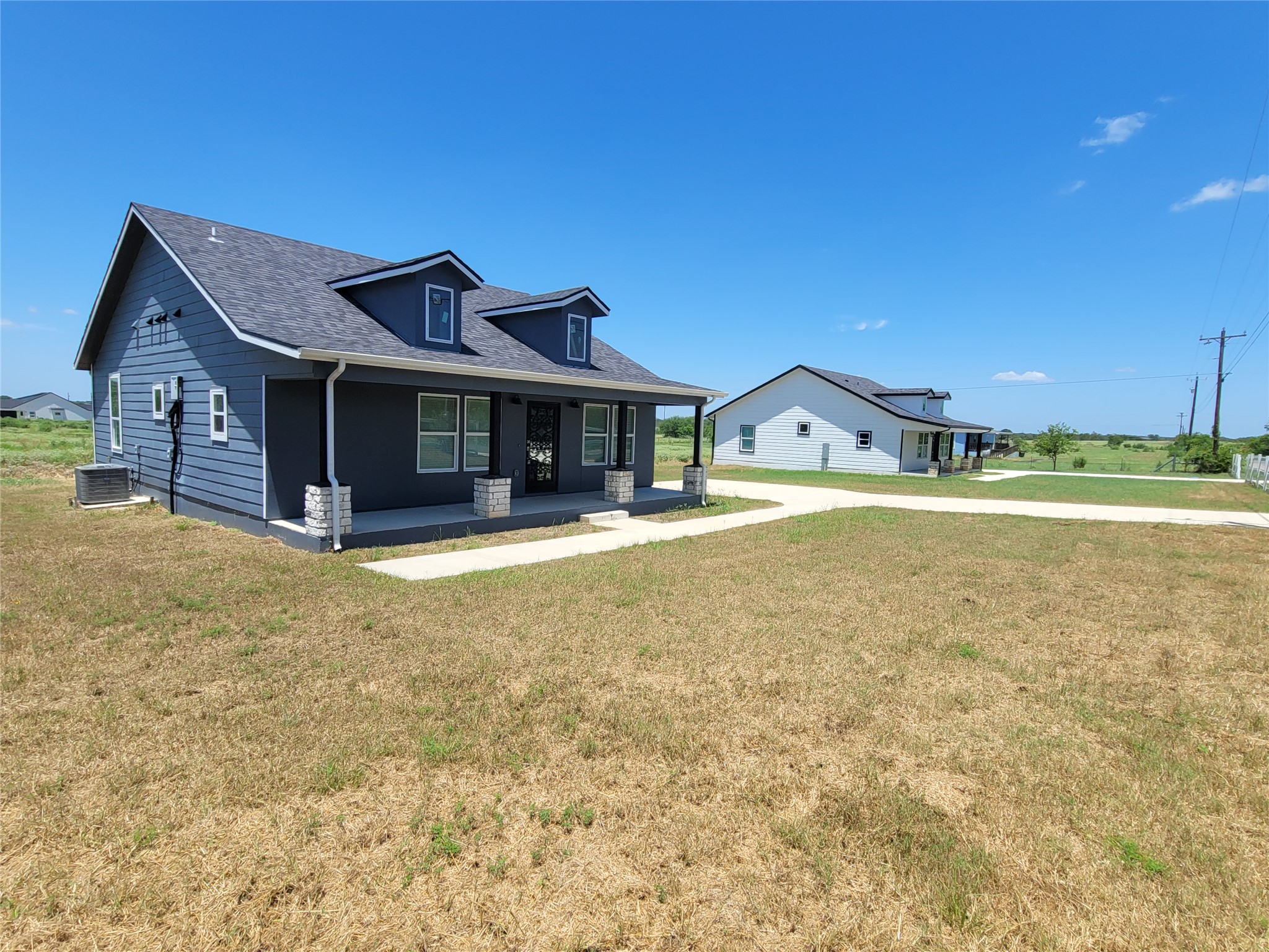 422 A Road Stockdale, TX 78160 - Photo 39 of 40 A classic facade with a covered porch offers inviting curb appeal.