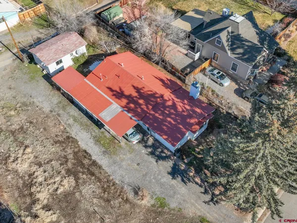 an aerial view of a house with a yard