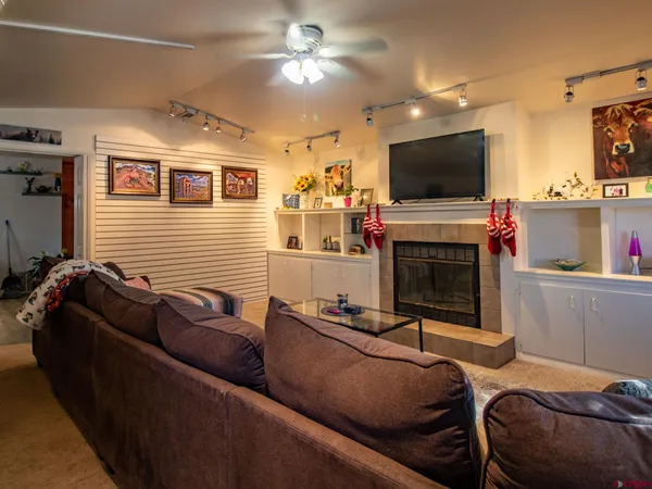 a kitchen with stainless steel appliances granite countertop a dining table chairs and a refrigerator