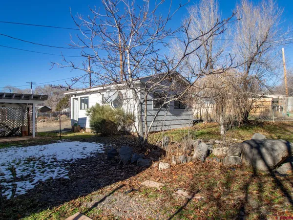 an empty room with wooden floor and a window