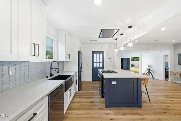 a kitchen with stainless steel appliances granite countertop a sink and cabinets