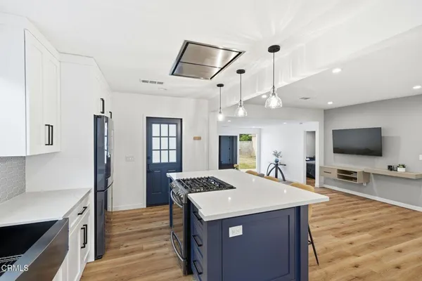 a view of kitchen with sink microwave and refrigerator