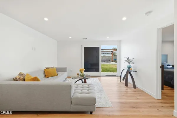 a living room with furniture rug and a large window