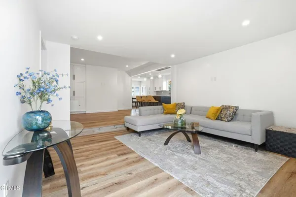 a living room with furniture and potted plant
