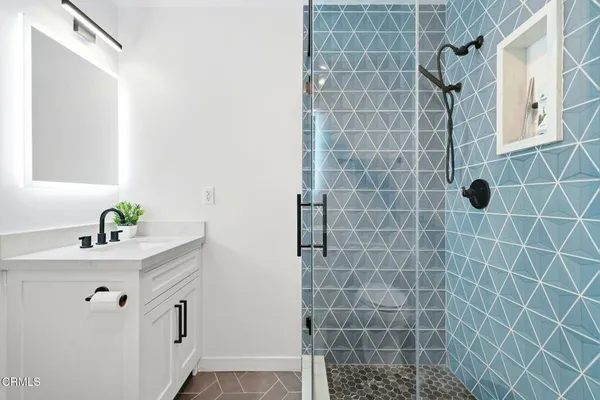 a bath room with a shower and a sink