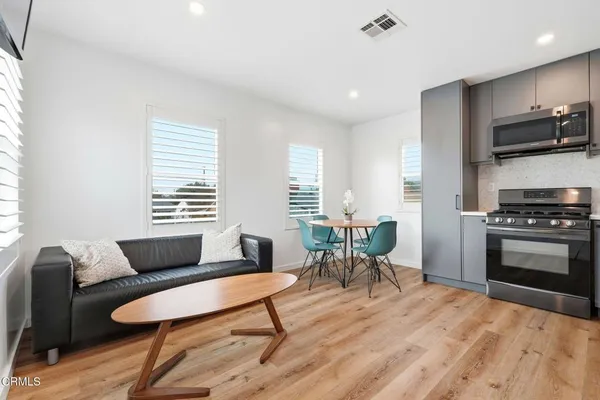a living room with furniture and a wooden floor