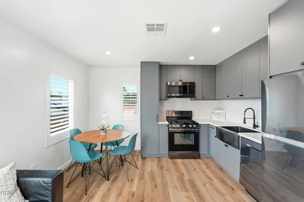 a kitchen with stainless steel appliances kitchen island granite countertop a sink and cabinets