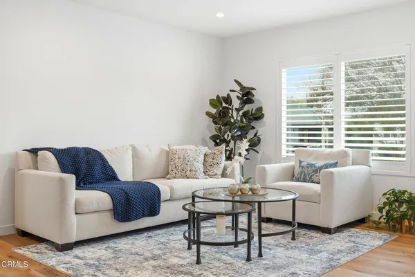 a living room with furniture and a large window