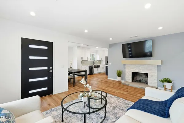 a living room with furniture a fireplace and a flat screen tv