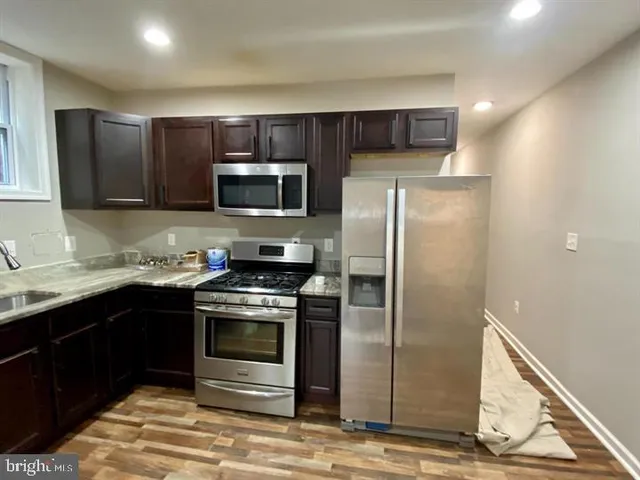 a kitchen with a sink stove and refrigerator